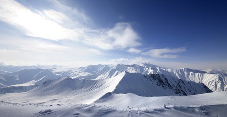 Panoramic view on snowy sunlight mountains at winter evening. Caucasus Mountains, Georgia, region Gudauri.の写真素材