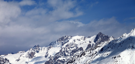 Panoramic view on snowy mountains with glacier and cloudy blue sky in nice sunny day. Caucasus Mountains at winter. Svaneti region of Georgia.の写真素材