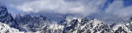 Panorama of snowy mountains in haze at sunny winter day. Caucasus Mountains. Svaneti region of Georgia.の写真素材