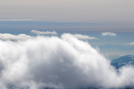Mountains in sunlight clouds at winter evening. Caucasus Mountains, Georgia, region Gudauri.の写真素材
