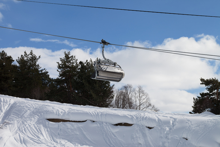 Chair-lift and snowy off-piste slope with traces from skis and snowboards in ski resort. Caucasus Mountains at winter. Tetnuldi, Svaneti region of Georgia.の写真素材