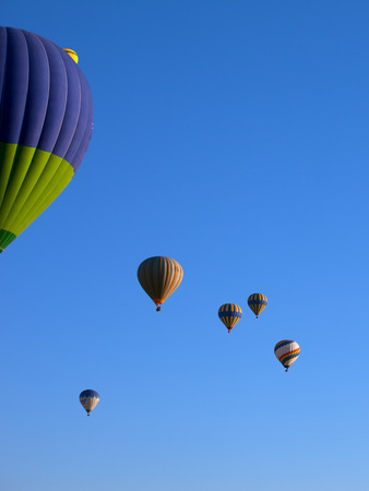 Multicolor hot air balloons on blue clear sunlight sky at early morningの写真素材