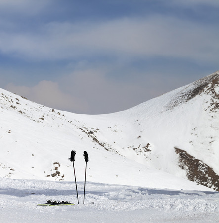 Skiing equipment on snowy ski slope at sunny winter day. Caucasus Mountains, Georgia, region Gudauri.の写真素材