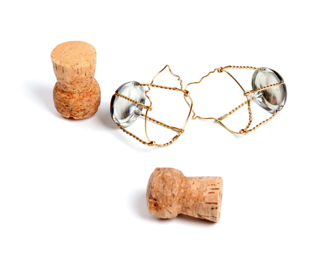 Two corks from champagne wine and muselets. Isolated on white background. Selective focus.の写真素材