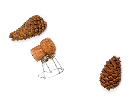 Fir cones and champagne wine cork with muselet. Isolated on white background. View from above.の写真素材