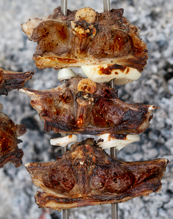 Kebab of lamb cooking in outdoor on campfire. Close-up view.の写真素材