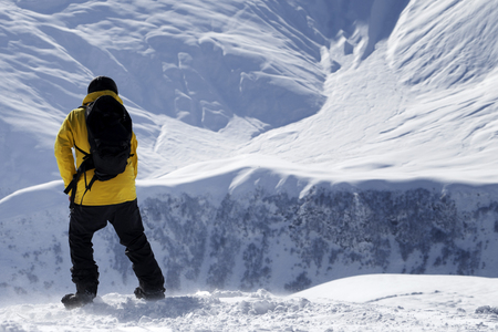 Snowboarder on top of snowy off-piste slope at windy winter day. Caucasus Mountains, Georgia, region Gudauri.の写真素材