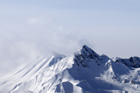 Snowy mountain peaks in haze. Caucasus Mountains, Georgia, region Gudauri at winter.の写真素材