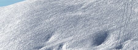Panoramic view on snowy off piste slope for freeride with traces from skis and snowboards at winterの写真素材