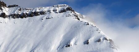 Panoramic view on snowy sunlight mountains in fog at nice sun day. Caucasus Mountains in winter, Georgia, region Gudauri.の写真素材