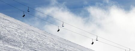Panoramic view on snow off-piste ski slope and chair-lift in fog. Caucasus Mountains in winter, Georgia, region Gudauri.

の写真素材