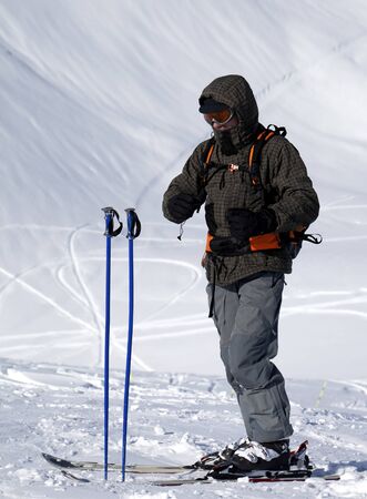 Skier on top mountain and snowy ski slope for freeriding at background. Caucasus Mountains. Georgia, region Gudauri in winter.の写真素材