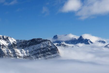 Snowy sunlight mountains in fog at nice sun day. Caucasus Mountains in winter, Georgia, region Gudauri.の写真素材