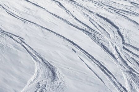 Ski slope for freeride and slalom with new-fallen snow and trace from skis and snowboards at winter dayの写真素材