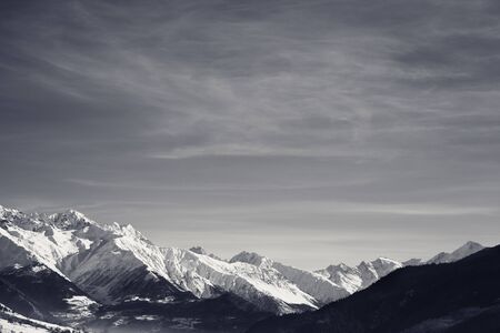 View on snowy mountains in nice sunny morning. Caucasus Mountains at winter. Svaneti region of Georgia. Black and white retro toned landscape.の写真素材