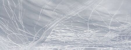 Panoramic view on snowy off-piste slope with traces of skis and snowboards at sun winter dayの写真素材