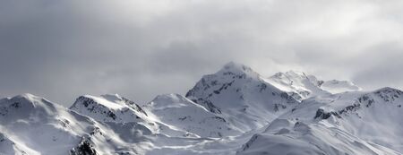 Panoramic view on evening snowy sunlight mountains in haze. Caucasus Mountains. Svaneti region of Georgia at winter.の写真素材