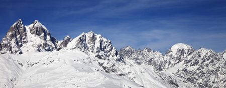 Panoramic view on Mount Ushba in winter at wind sunny day. Snowy Caucasus Mountains. Svaneti region of Georgia.の写真素材