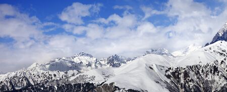 Panoramic view on snowy winter mountains in clouds. Caucasus Mountains, Svaneti region of Georgia.
