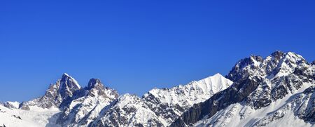 Panoramic view on snowy winter mountain peaks and blue clear sky at sunny day. Caucasus Mountains. Svaneti region of Georgia.の写真素材