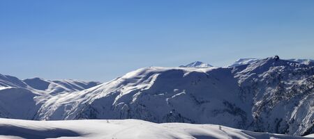 Panoramic view on snowy off-piste slope and blue clear sky in sun winter morning. Tetnuldi, Caucasus Mountains, Svaneti region of Georgia.の写真素材