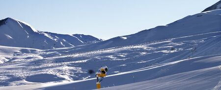 Ski resort at early winter morning. Snowy slope and blue clear sky. Caucasus Mountains, Mount Shahdagh, Azerbaijan. Panoramic view.の写真素材