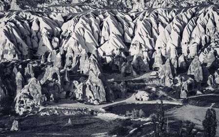View of Cappadocia valley at sunny evening. Turkey, Goreme. Black and white toned landscape.の写真素材