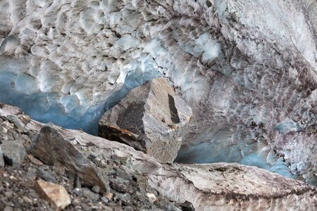 Glacier with deep danger crevasses and big stoneの写真素材
