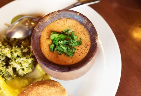 Lunch at Georgian cafe. Lobio of beans in clay pot, mchadi (cornbread), pickled appetizers: green...