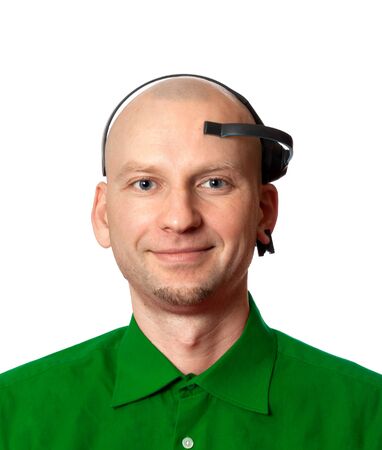 Portrait of young man in green shirt with EEG (electroencephalography) headset on head. Isolated on white background.の写真素材