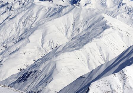 High mountains with sunlit snowy slope at cold winter day. Caucasus Mountains, Georgia region Gudauri.の写真素材