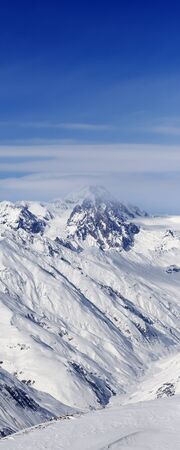 High snowy mountains and blue sky with clouds at sunny winter day. Caucasus Mountains, Georgia region Gudauri.の写真素材