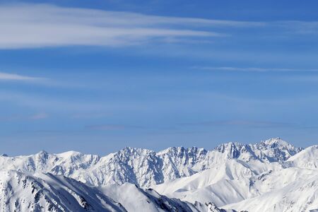 High snowy mountains and blue sky with clouds at cold winter day. Caucasus Mountains, Georgia region Gudauri.の写真素材