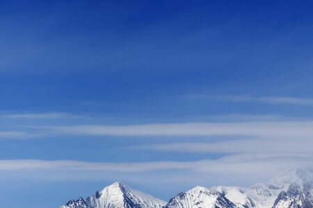 High snowy mountains and blue sky with clouds at cold winter day. Caucasus Mountains, Georgia region Gudauri.の写真素材
