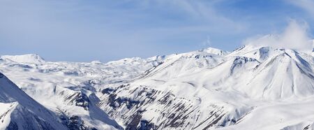 Panorama of winter snowy mountains and blue cloudy sky at nice sunny day. Caucasus Mountains, Georgia.Region Gudauri.の写真素材
