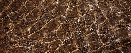 Natural water background. Stream shining in sun at hot summer day. Panoramic view from above.の写真素材