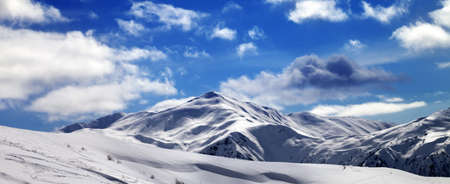 Panoramic view on off-piste ski slope and beautiful sky with clouds in sun evening. Tetnuldi, Caucasus Mountains, Svaneti region of Georgia.の写真素材