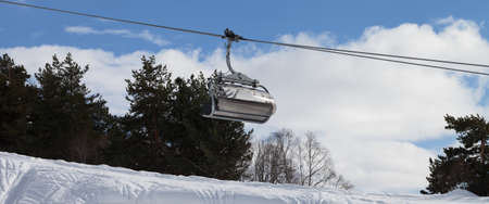 Panoramic view on chair-lift and snowy off-piste slope with traces from skis and snowboards in ski resort. Caucasus Mountains at winter. Tetnuldi, Svaneti region of Georgia.の写真素材