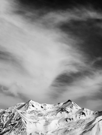 Black and white winter snowy mountains at windy day. Caucasus Mountains, Georgia, Gudauri. View from ski resort. High contrast.の写真素材