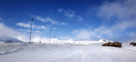 Panoramic view on snowy ski slope and hotel in high winter mountains. Georgia, region Gudauri. Caucasus Mountains.の写真素材