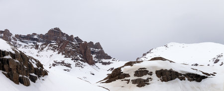 Snowy rocky mountains at cloudy day. Turkey, Central Taurus Mountains, Aladaglar (Anti Taurus) view from plateau Edigel (Yedi Goller). Panoramic view.の写真素材