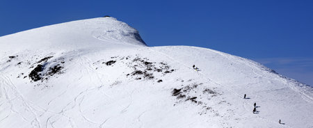 Snowboarders and skiers on snowy off piste slope at sun day. Caucasus Mountains at winter, Georgia, region Gudauri.の写真素材
