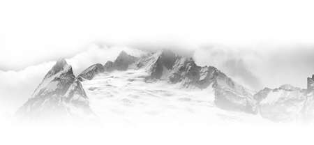 Black and white panorama of winter snowy high mountains in fog. Caucasus Mountains, region Dombay, Peak Ine. White background for copy space on top and bottom of image.の写真素材