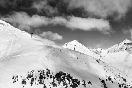 Off-piste slope and chair-lift on ski resort at sun day. Caucasus Mountains in winter, Georgia,...