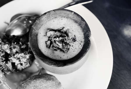 Black and white lunch at Georgian cafe. Lobio of beans in clay pot, mchadi (cornbread), pickled appetizers: hot pepper, jonjoli (Staphylea colchica). Traditional Georgian cuisine. View from above.の写真素材