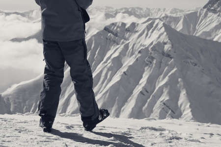 Skier on top of snowy mountain in nice winter day. Caucasus Mountains in winter, Georgia, region Gudauri. Black and white retro toned image.の写真素材