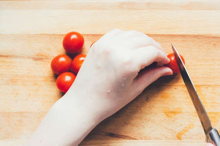 homemade pizza step by step instruction.DIY pizza step 5.gently chop the tomatoes. Woman's hands...