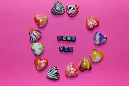 Valentine's Day background. Hearts and inscription on pastel pink background, copy space. Valentines...