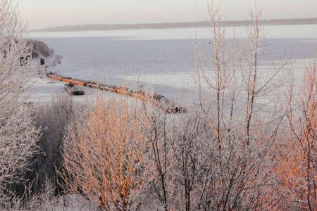 frozen Volga river with barges. winter river landscape.