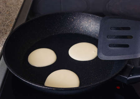 pancakes instruction step by step.step 2 put the dough in a pan. Pancakes are fried in a black...